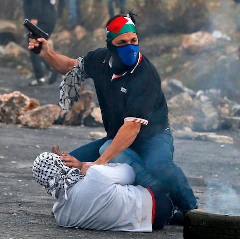 An undercover Israeli policeman detains a Palestinian protestor during clashes - Credit: ABBAS MOMANI/AFP/Getty Images