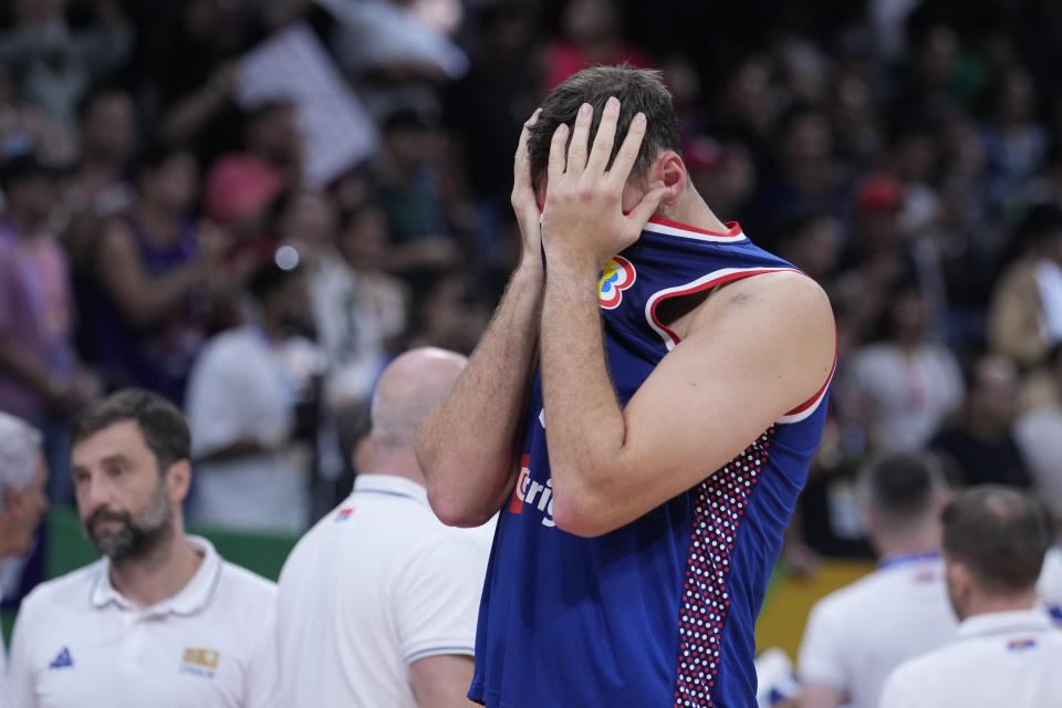 Serbia center Nikola Milutinov (33) reacts after losing to Germany in the championship game of the Basketball World Cup in Manila, Philippines, Sunday, Sept. 10, 2023. (AP Photo/Michael Conroy)