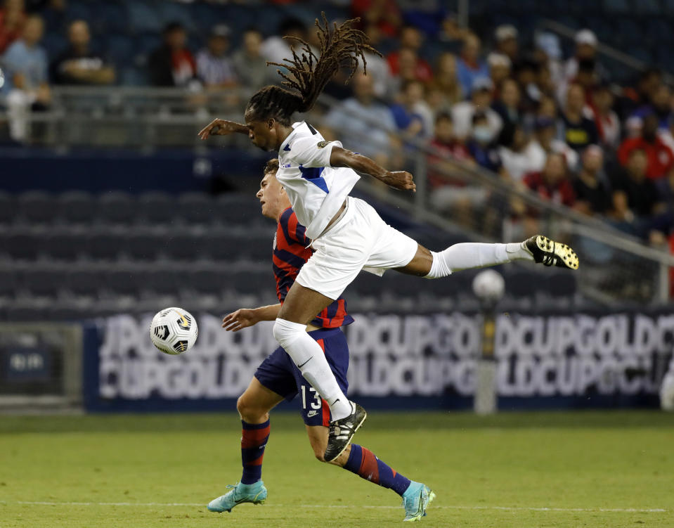 United States forward Matthew Hoppe, rear, and Martinique defender Dondon Gerald vie for the ball during the first half of a CONCACAF Gold Cup soccer match in Kansas City, Kan., Thursday, July 15, 2021. (AP Photo/Colin E. Braley)