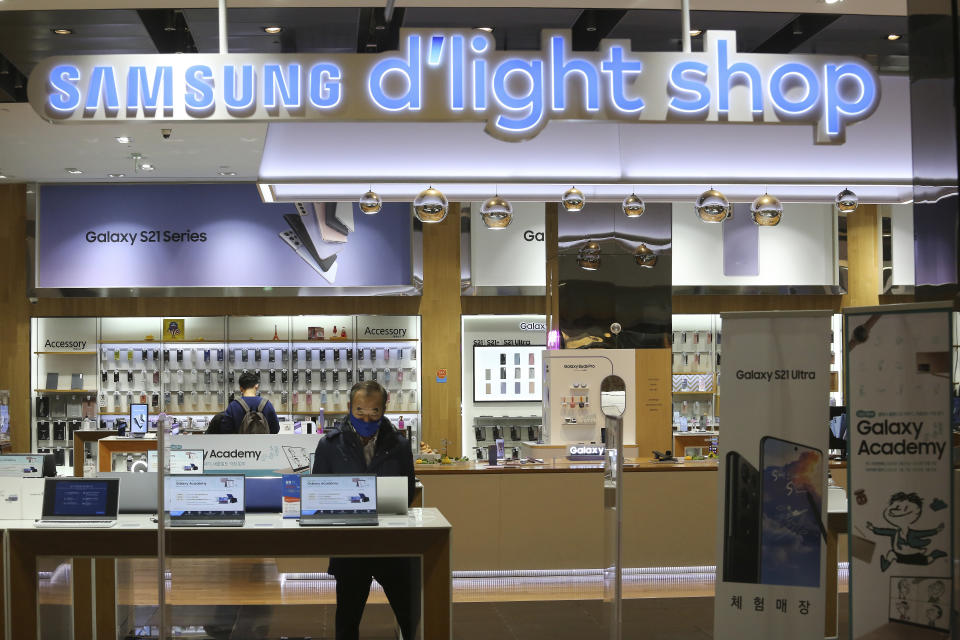 A visitor tries out Samsung Electronics' notebook at its shop in Seoul, South Korea, Thursday, Jan. 28, 2021. Samsung Electronics Co. said Thursday its operating profit for last quarter rose by more than 26% as it capped off a robust business year where its dual strength in parts and finished products allowed it to thrive amid the pandemic. (AP Photo/Ahn Young-joon)