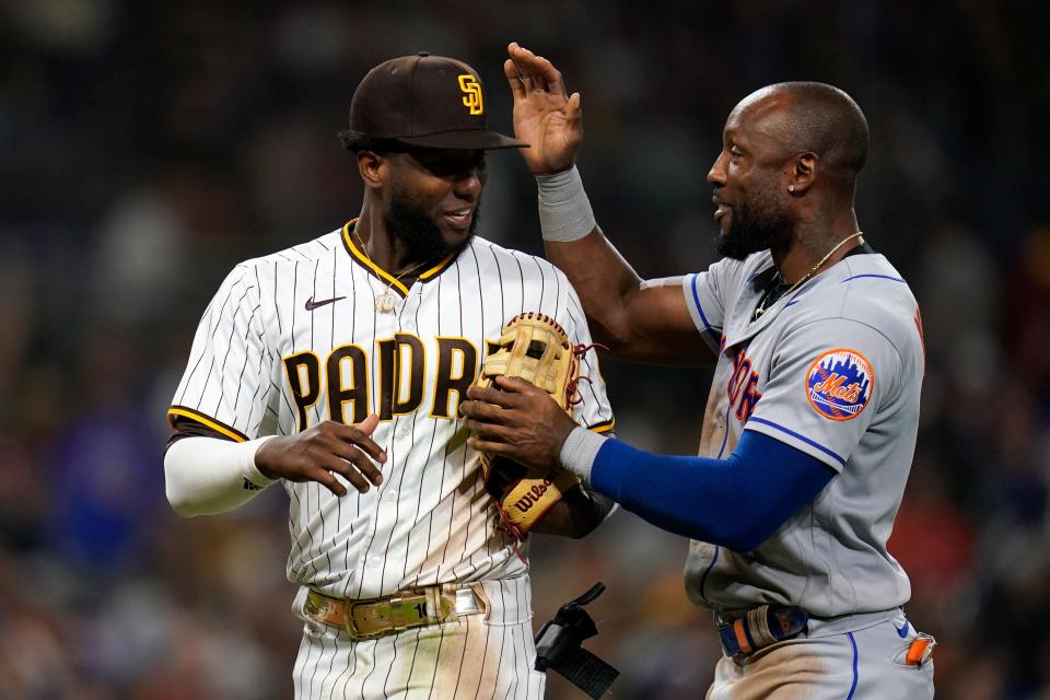 New York Mets' Starling Marte, right, jokes with San Diego Padres left fielder Jurickson Profar after Profar made the catch for the out on Marte during the sixth inning of a baseball game Monday, June 6, 2022, in San Diego.