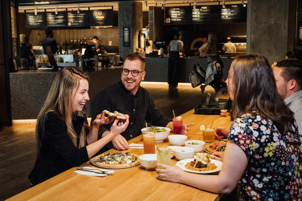 A table of friend enjoys a meal at Time Out Market in Montreal