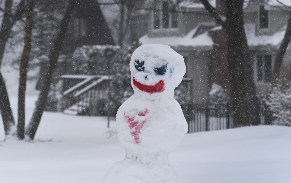 A snowman stands in a yard in Lake Zurich, Ill., during a winter storm, Tuesday, Jan. 26. 2021. (Paul Valade/Daily Herald via AP)