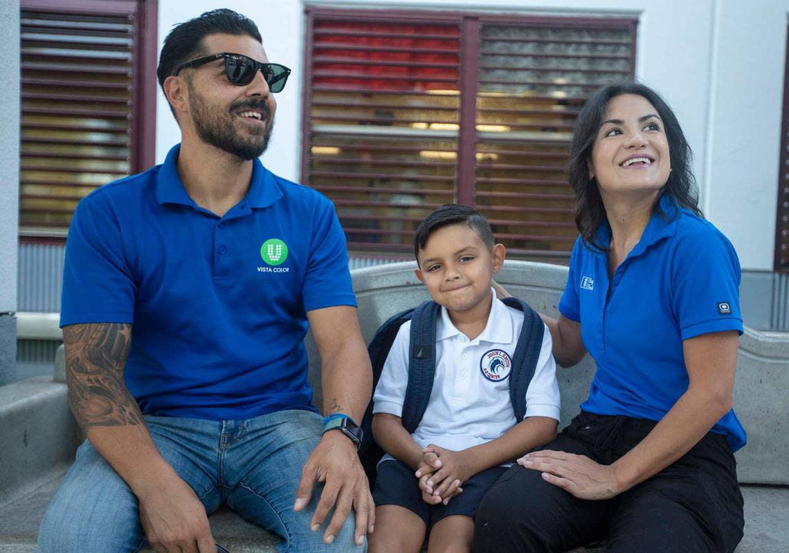 From left: David Cardounel and Estephany Giraldo sit with their son, John Cardounel, 7, on the first day of classes at John I. Smith K-8 Center in Doral on Wednesday, Aug. 17, 2022. John said he was nervous and had butterflies as he was about to enter second grade.