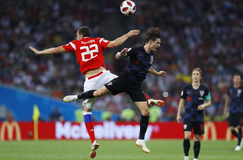 <p>Artyom Dzyuba jumps for the ball with Croatia’s Sime Vrsaljko </p>