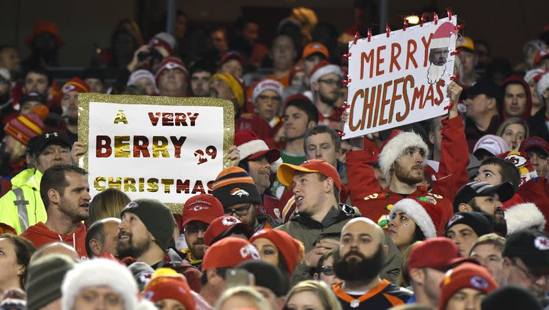 Kansas City Chiefs fans hold up Christmas greeting signs during the first half of an NFL football game against the Denver Broncos in Kansas City, Mo., Sunday, Dec. 25, 2016.