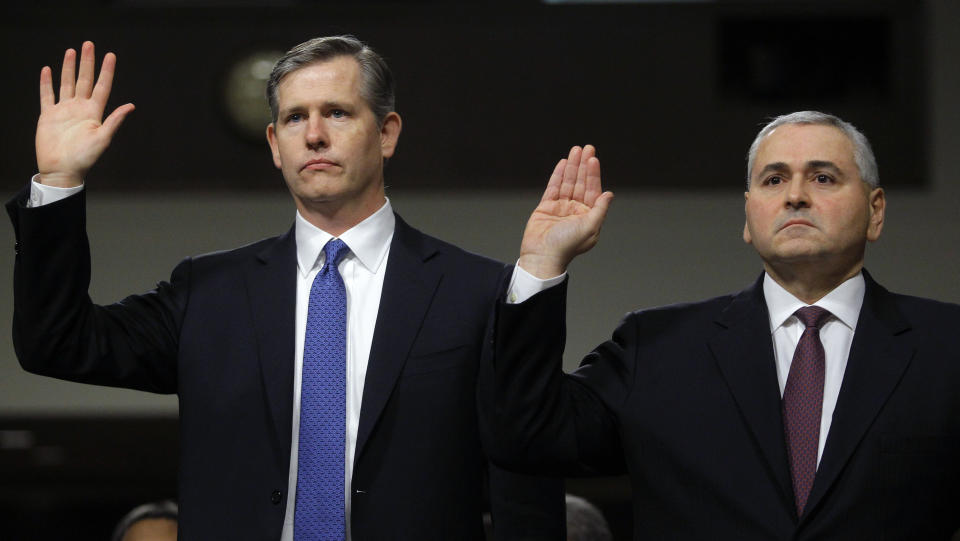 Michael Cavanagh, (L), the head of JPMorgan Chase Management Task Force Reviewing CIO Losses, and Douglas Braunstein, (R), Current Vice-Chairman and former Chief Financial Officer of JPMorgan Chase Bank, are sworn in at the Senate Homeland Security Investigations Subcommittee in Washington March 15, 2013. The Subcommittee is investigating JPMorgan Chase's Whale Trades.    REUTERS/Gary Cameron    (UNITED STATES - Tags: POLITICS BUSINESS)