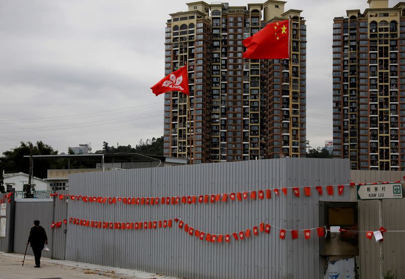 FILE PHOTO: A woman walks in Kaw Liu village in Hong Kong