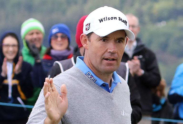 Irish golfer Padraig Harrington waves to the crowd after playing his tee shot on the 17th green on the second day of the Irish Open at the Royal County Down Golf Club in Newcastle in Northern Ireland on May 29, 2015