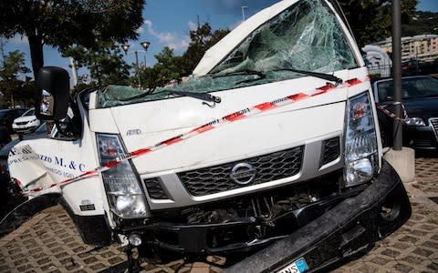 A wrecked truck sits in an Ikea car park near to the Morandi Bridge  - Credit: Jack Taylor/Getty Images