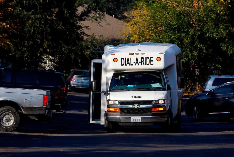 A Ben Franklin Transit Dial-A-Ride bus stops an apartment complex off West Fourth Avenue near downtown Kennewick.