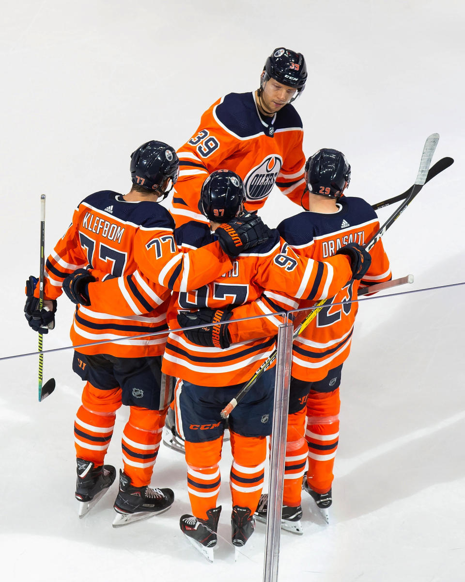 Edmonton Oilers' Oscar Klefbom (77), Alex Chiasson (39), Connor McDavid (97) and Leon Draisaitl (29) celebrate a goal against the Chicago Blackhawks during the second period of an NHL hockey playoff game Monday, Aug. 3, 2020, in Edmonton, Alberta. (Codie McLachlan/The Canadian Press via AP)