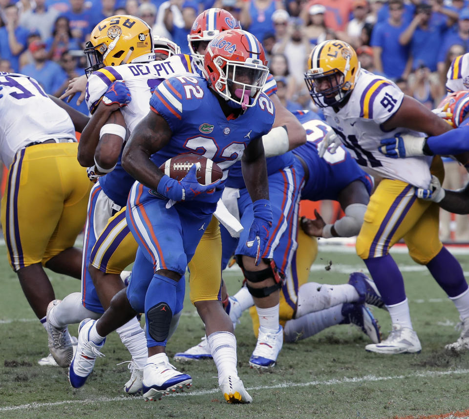 Florida running back Lamical Perine (22) runs past the LSU defense for a 1-yard touchdown during the first half of an NCAA college football game, Saturday, Oct. 6, 2018, in Gainesville, Fla. (AP Photo/John Raoux)