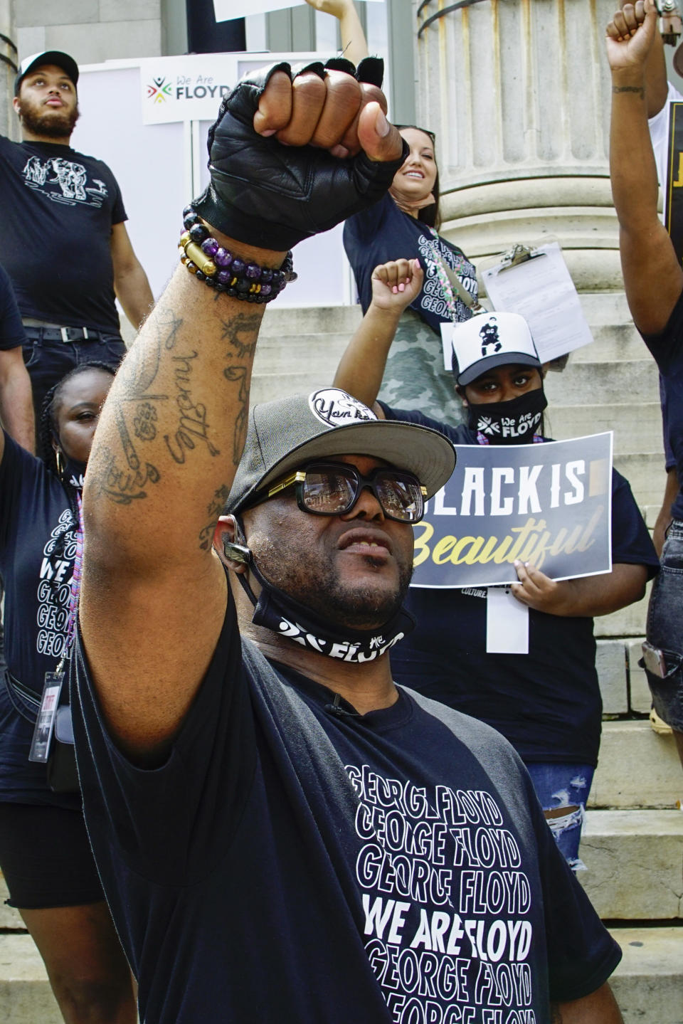 Terrence Floyd, brother of George Floyd, raises his fist with others during a rally on Sunday, May 23, 2021, in Brooklyn borough of New York. George Floyd, whose May 25, 2020 death in Minneapolis was captured on video, plead for air as he was pinned under the knee of former officer Derek Chauvin, who was convicted of murder and manslaughter in April 2021. (AP Photo/Eduardo Munoz Alvarez)