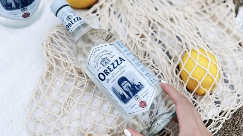 Orezza Mineral Water in glass bottle with lemons