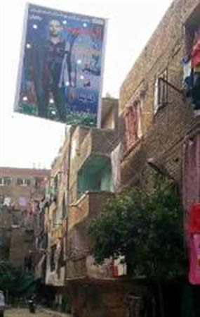 A banner bearing a picture of Mohamed Sayid, a militant killed in a March 19 gun battle with security forces, in which he is named as a "martyr", is seen on a street near his flat in the Matariya area of Cairo, in this picture taken April 13, 2014. Picture taken April 13. To match Insight EGYPT-MILITANCY/ REUTERS/Stringer