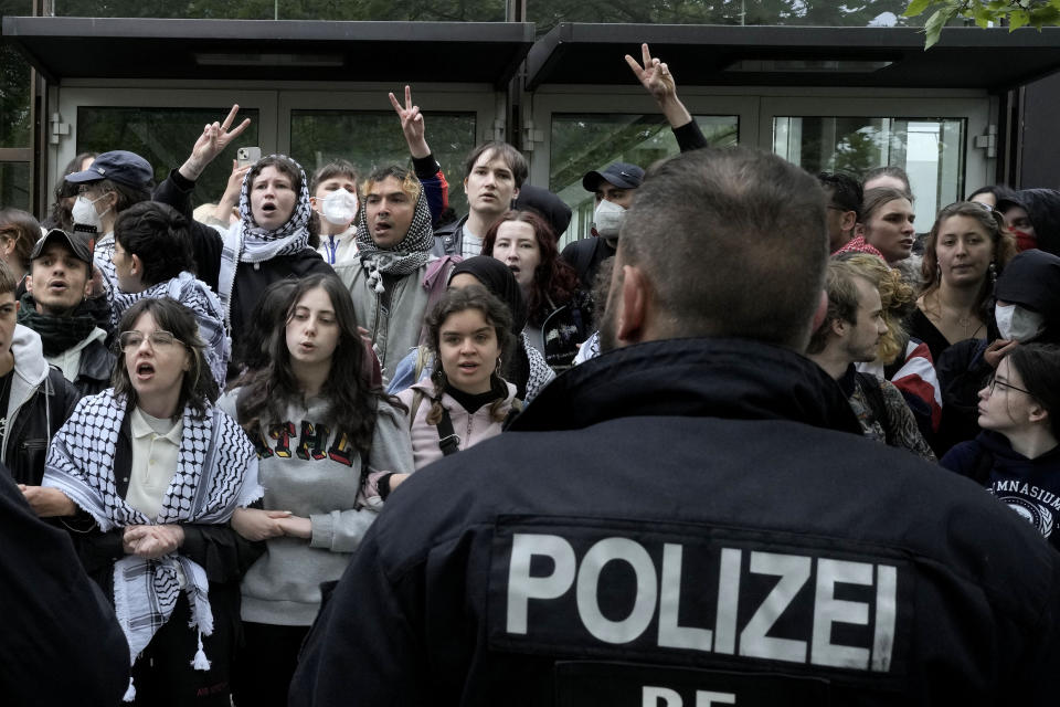 Participants face German police officers during a pro-Palestinians demonstration by the group "Student Coalition Berlin" in the theater courtyard of the 'Freie Universität Berlin' university in Berlin, Germany, Tuesday, May 7, 2024. Pro-Palestinian activists occupied a courtyard of the Free University in Berlin on Tuesday. (AP Photo/Markus Schreiber)