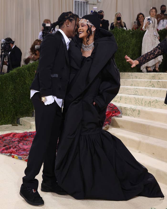 Rihanna and ASAP Rocky smiling on the steps at the 2021 Met Gala