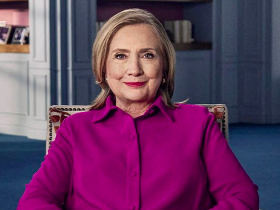 Hillary Clinton in a dark-pink top. 