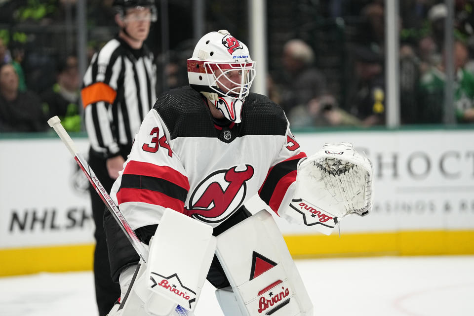 New Jersey Devils goaltender Jake Allen minds the net during a face off in the first period of an NHL hockey game against the Dallas Stars in Dallas, Thursday, March 14, 2024. (AP Photo/Tony Gutierrez)