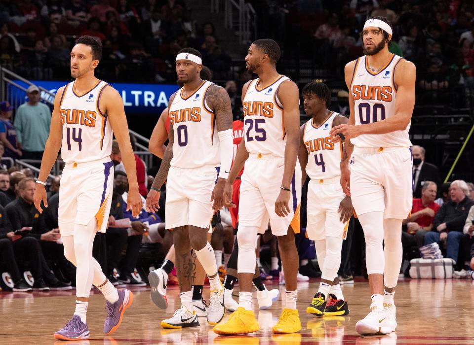 Mar 16, 2022; Houston, Texas, USA; Phoenix Suns guard Landry Shamet (14) forward Torrey Craig (0) and forward Mikal Bridges (25) and guard Aaron Holiday (4) and center JaVale McGee (00) come out to play against the Houston Rockets in the fourth quarter at Toyota Center.