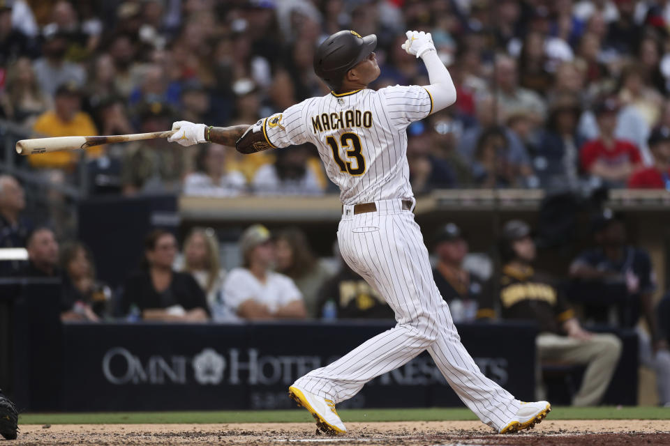 San Diego Padres' Manny Machado watches his grand slam against the Atlanta Braves in the fifth inning of a baseball game Saturday, Sept. 25, 2021, in San Diego. (AP Photo/Derrick Tuskan)