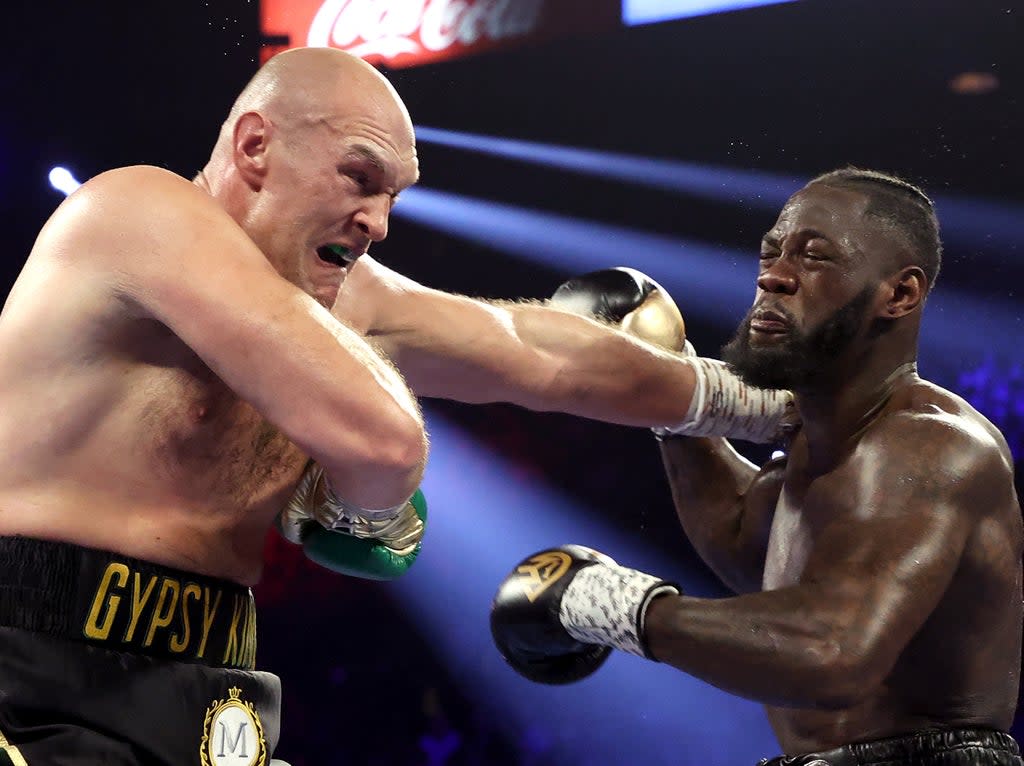 Deontay Wilder (right) and Tyson Fury exchange punches in their rematch (Getty Images)