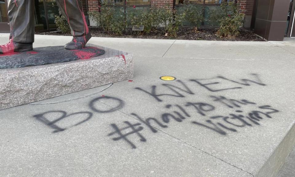 Graffiti at the foot of Bo Schembechler’s statue on the Michigan campus