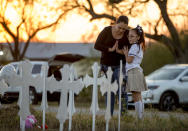 <p>Meredith Cooper, of San Antonio, Texas, and her 8-year-old daughter, Heather, visit a memorial of 26 metal crosses near First Baptist Church in Sutherland Springs, Texas, Monday Nov. 6, 2017. (Photo: Jay Janner/Austin American-Statesman via AP) </p>