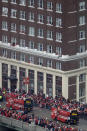Busses carrying members of the Kansas City Chiefs travel in a parade through downtown Kansas City, Mo., Wednesday, Feb. 5, 2020m to celebrate the Chiefs victory in the NFL's Super Bowl 54. (AP Photo/Charlie Riedel)