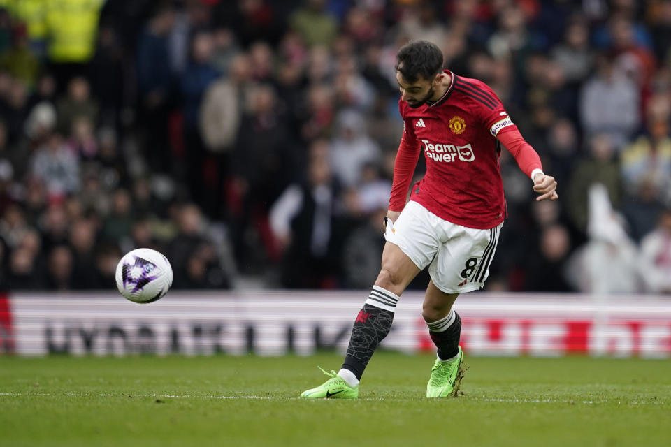 Manchester United's Bruno Fernandes scores his side's first goal during the English Premier League soccer match between Manchester United and Liverpool at the Old Trafford stadium in Manchester, England, Sunday, April 7, 2024. (AP Photo/Dave Thompson)