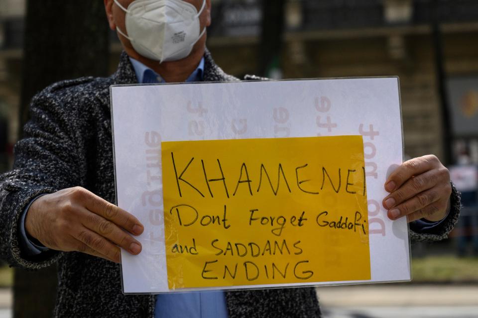 A  protester displays a banner outside the talks in ViennaEPA