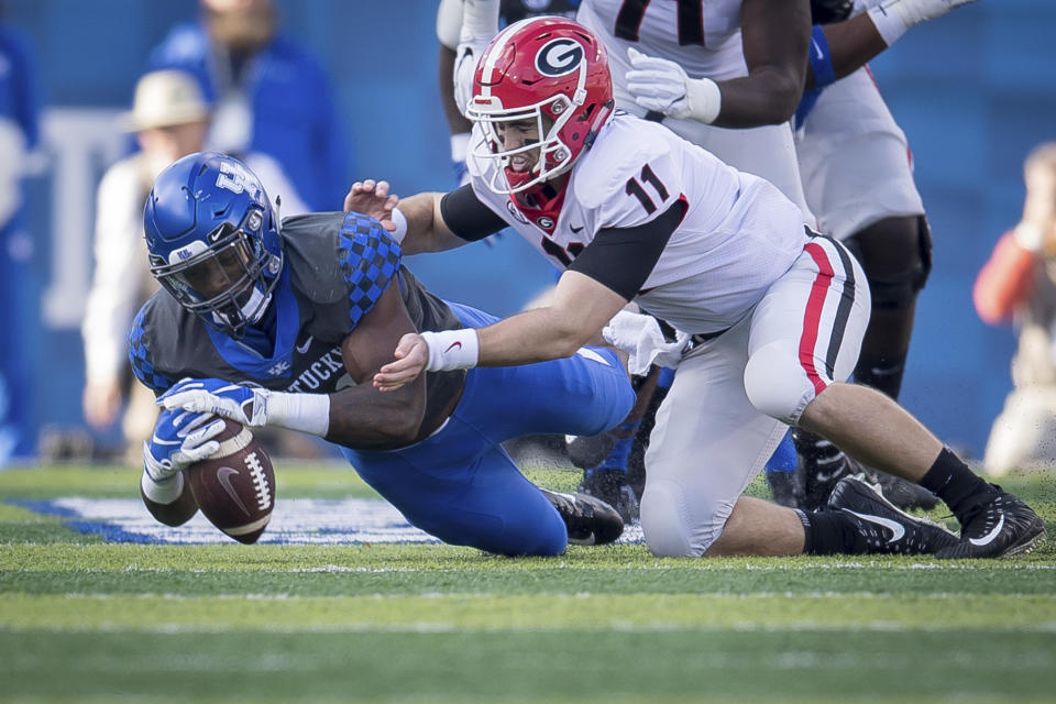 Kentucky linebacker Josh Allen (41) dives on the fumble of Georgia quarterback Jake Fromm (11) during the first half an NCAA college football game in Lexington, Ky., Saturday, Nov. 3, 2018. (AP Photo/Bryan Woolston)