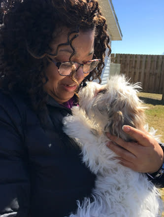 In a photo provided by Candace Croney, Croney holds her dog, Desi, in April 2019, in Indiana. “If we think how much time most of our pets prior to the pandemic typically would spend without people around to 24 hours a day, seven days a week, it’s quite a lot,” says Croney, a Purdue University professor who teaches about animal behavior. (Courtesy of Candace Croney via AP)