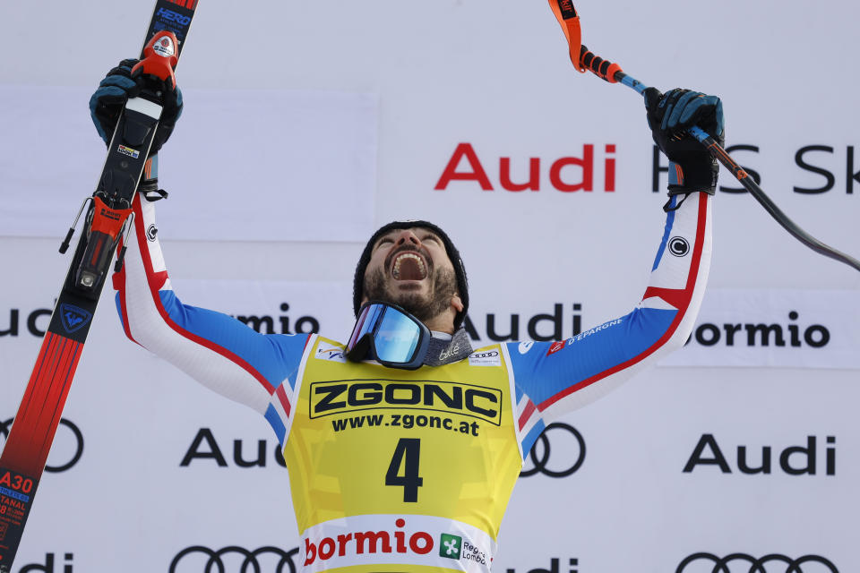 France's Cyprien Sarrazin celebrates on the podium after winning an alpine ski, men's World Cup downhill race, in Bormio, Italy, Thursday, Dec. 28, 2023. (AP Photo/Alessandro Trovati)