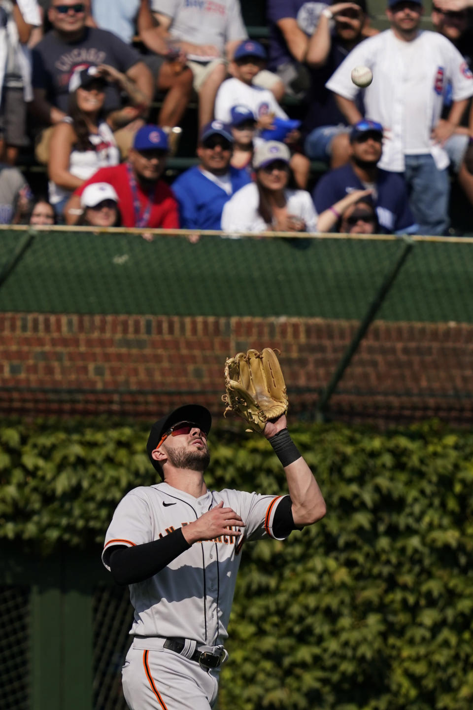 San Francisco Giants left fielder Kris Bryant catches a fly ball hit by Chicago Cubs' Ian Happ during the sixth inning of a baseball game in Chicago, Friday, Sept. 10, 2021. (AP Photo/Nam Y. Huh)