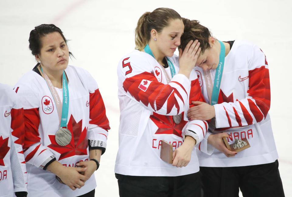 <p>Canada defenseman Lauriane Rougeau (5) consoles Canada forward Rebecca Johnston (6) after receiving their silver medals, Brigette Lacquette (4) is on the left as Canada loses in a shootout to the United States in the Olympic women’s hockey gold medal game at the Gangneung Hockey Centre in Gangneung in Pyeongchang in South Korea. February 22, 2018. (Steve Russell/Toronto Star via Getty Images) </p>