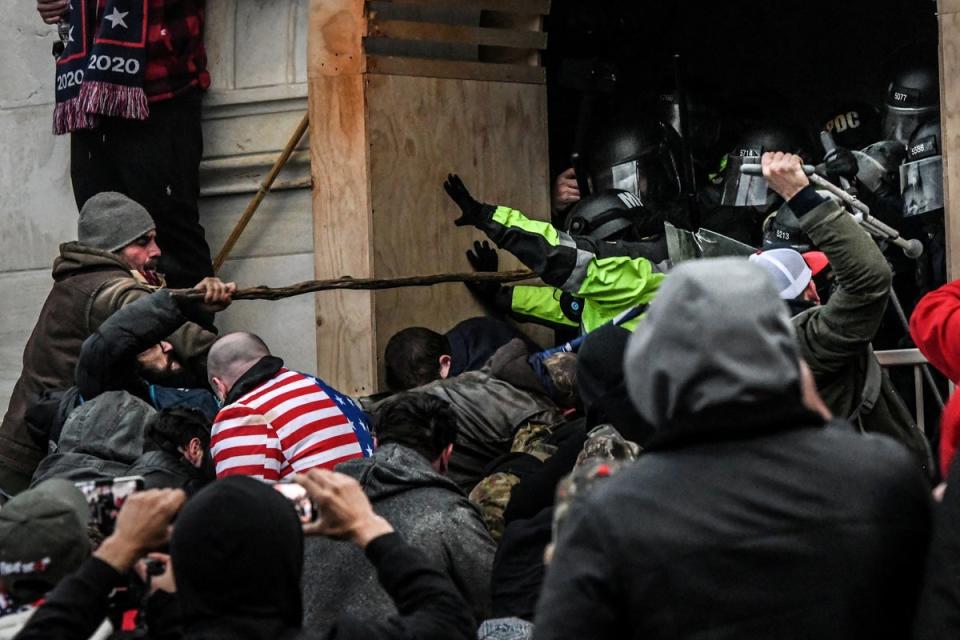 A mob at the US Capitol fights law enforcement on 6 January, 2021. (REUTERS)