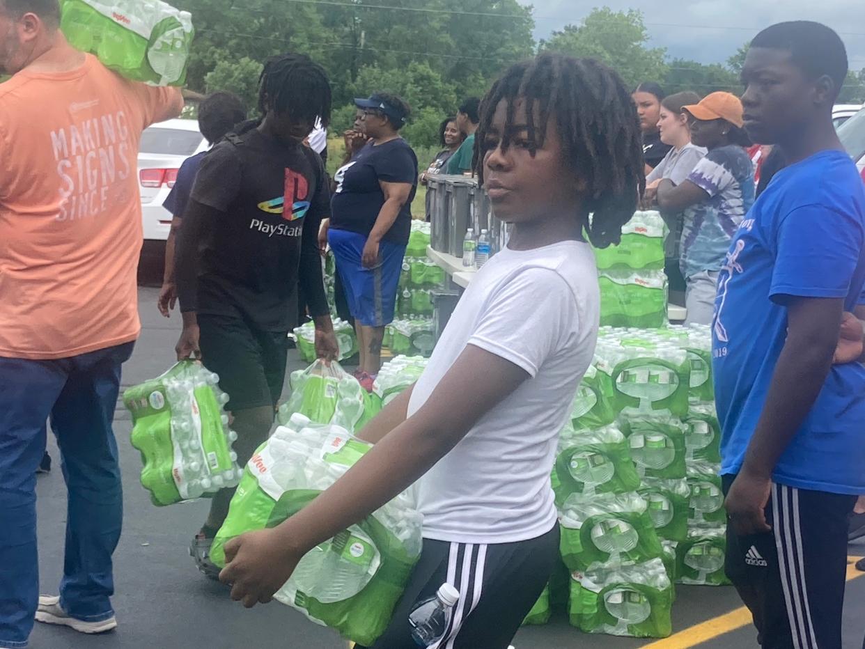 Zihon Kantako, 12, of Springfield, volunteered at a food and bottled water giveaway coordinated by the American Red Cross and Meridian at Plumbers, Steamfitters & HVACR Local 137, 2880 E. Cook St., on Sunday. Volunteers gave out some 1,500 lunches and were later going into neighborhoods that lost power to give away another 200 lunches. At the peak, some 40,000 City Water, Light & Power customers lost service from Thursday's storm.