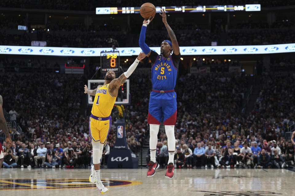 Denver Nuggets guard Kentavious Caldwell-Pope (5) shoots over Los Angeles Lakers guard D'Angelo Russell (1) during the second half of Game 1 of the NBA basketball Western Conference Finals series, Tuesday, May 16, 2023, in Denver. (AP Photo/Jack Dempsey)