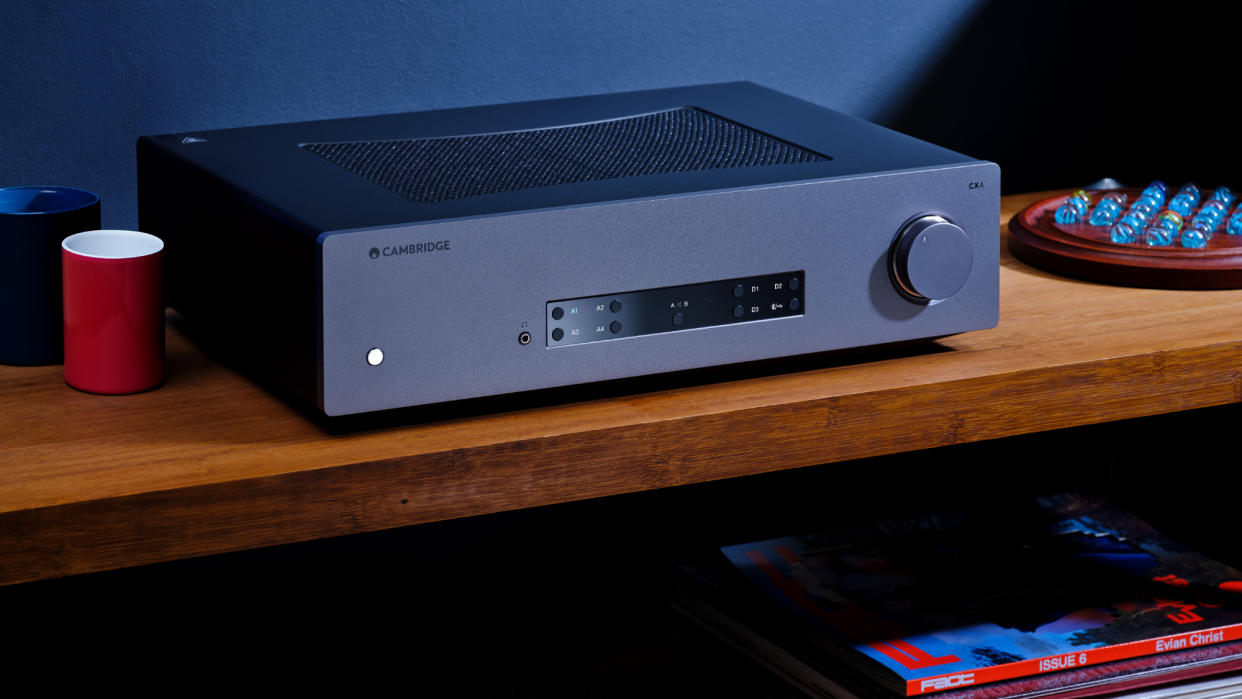  Cambridge Audio CXA81 Mk II in moody lifestyle setting on wooden shelf. 