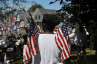 <p>A woman holds U.S. flags during a parade marking Independence Day in Deer Isle, Maine, July 4, 2017. (Photo: Shannon Stapleton/Reuters) </p>