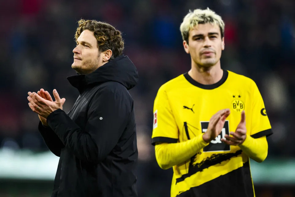 16 December 2023, Bavaria, Augsburg: Soccer: Bundesliga, FC Augsburg - Borussia Dortmund, Matchday 15, WWK-Arena. Dortmund coach Edin Terzic (l) and Dortmund's Gio Reyna (r) thank the fans for their support after the match. Photo: Tom Weller/dpa - IMPORTANT NOTE: In accordance with the regulations of the DFL German Football League and the DFB German Football Association, it is prohibited to utilize or have utilized photographs taken in the stadium and/or of the match in the form of sequential images and/or video-like photo series. (Photo by Tom Weller/picture alliance via Getty Images)