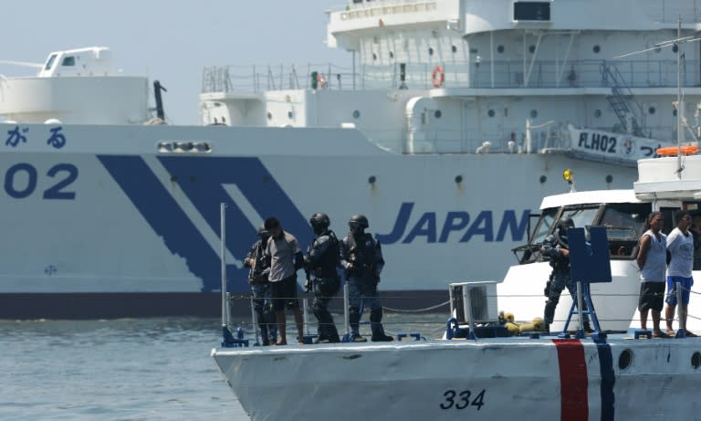 Philippine and Japanese coast guards are seen aboard a boat during their annual joint anti-piracy exercise in the waters off Manila Bay in July 2016