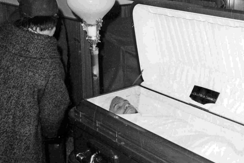 FILE — Malcolm X's widow, Betty Shabazz, looks at the body of her husband before the casket is closed, after funeral services at the Faith Temple of God in Christ, in New York's Harlem neighborhood, Feb. 27, 1965. Two of the three men convicted in the assassination of Malcolm X are set to be cleared Thursday, Nov. 18, 2021, after insisting on their innocence since the 1965 killing of one of the United States' most formidable fighters for civil rights, Manhattan's top prosecutor said Wednesday, Nov. 17, 2021. (AP Photo, File)