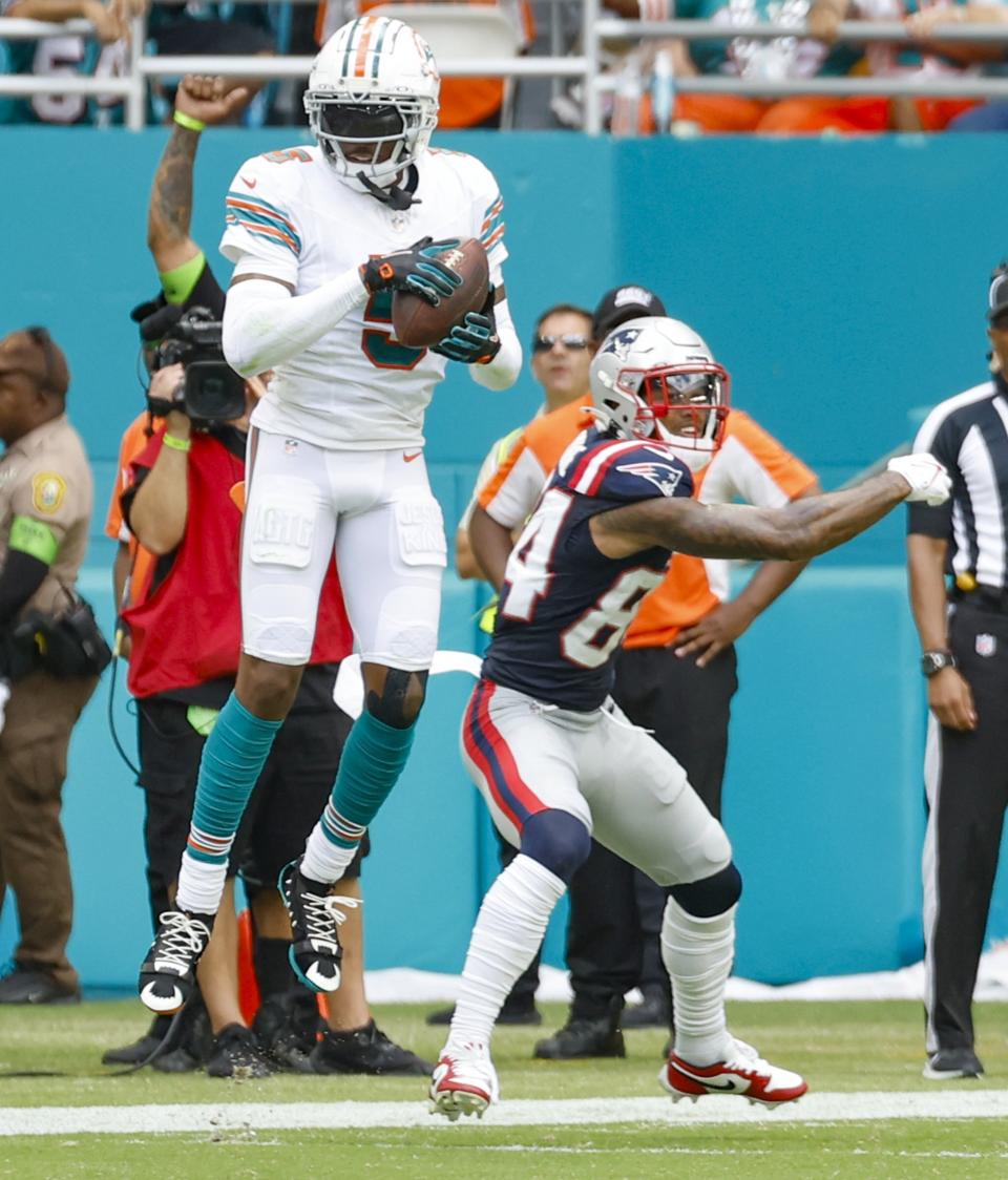 Miami Dolphins cornerback Jalen Ramsey (5) intercepts a pass intended for New England Patriots linebacker Jahlani Tavai (48) in the second quarter of an NFL football game in Miami Gardens, Fla., Sunday, Oct. 29, 2023. (Al Diaz/Miami Herald via AP)