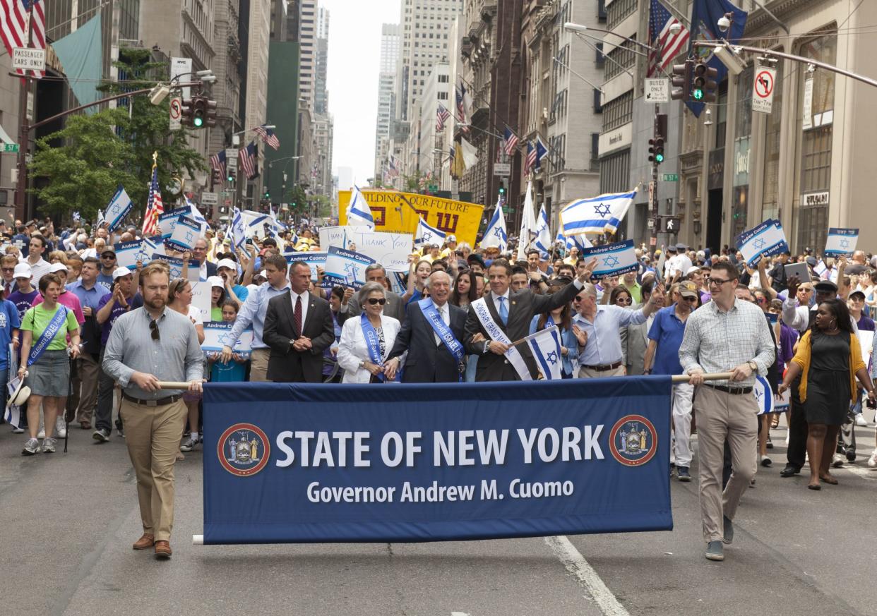 State of New York Governor Andrew Cuomo during Israel Day Parade in New York City, huge crowd walking in the middle of the street