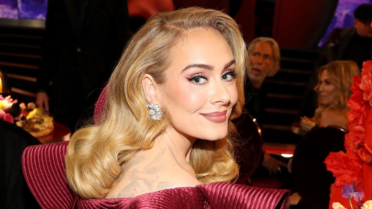  Adele wears a red dress as she attends the 65th GRAMMY Awards at Crypto.com Arena on February 05, 2023 in Los Angeles, California. 