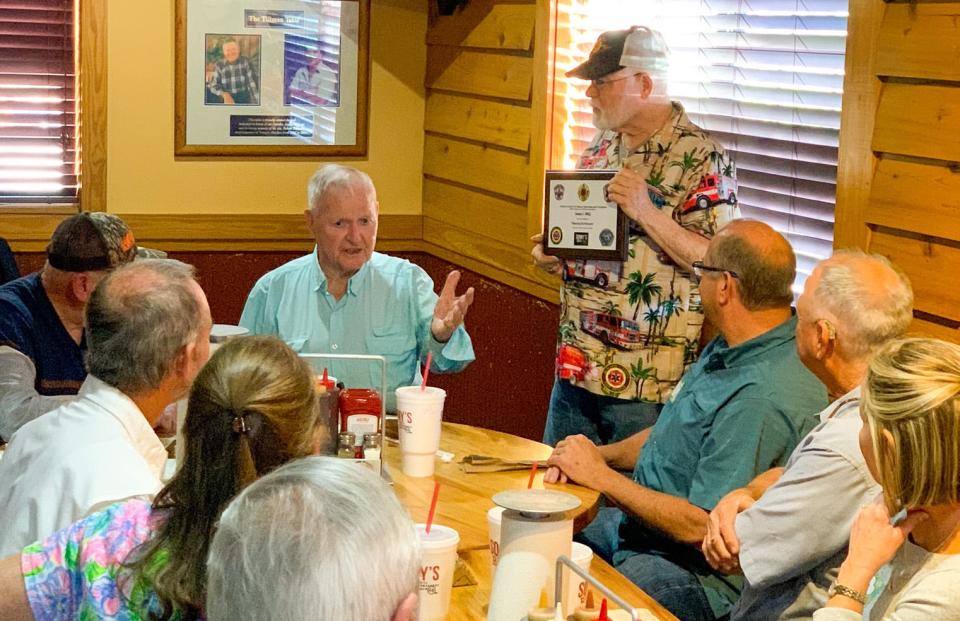 Sonny's BBQ founder Sonny Tillman, seated at center, is honored with the 
"Rescuers of Rescuers" award on Friday for more than 50 years of support for local first responders.