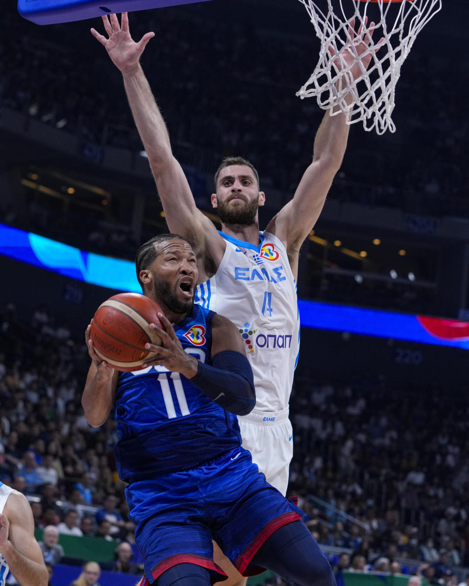 U.S. guard Jalen Brunson (11) is fouled by Greece center Georgios Papagiannis (14) as he shots during the first half of a Basketball World Cup group C match in Manila, Philippines Monday, Aug. 28, 2023.(AP Photo/Michael Conroy)